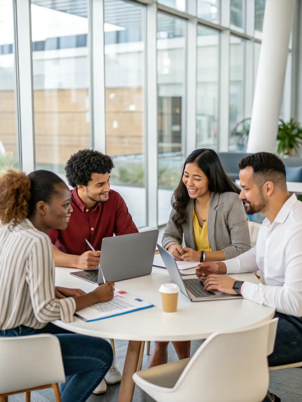 A diverse team of business professionals collaborating around a table, brainstorming ideas and discussing growth strategies in a brightly lit conference room.